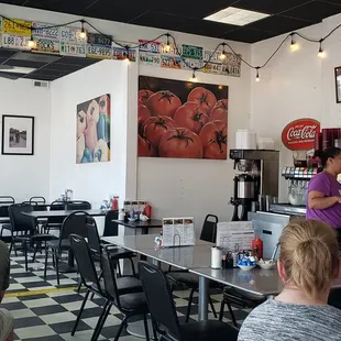 people sitting at tables in a restaurant