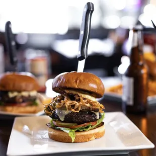 a burger with a knife stuck in it