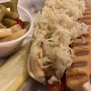 Sauerkraut and brown mustard hot dog with three bean salad