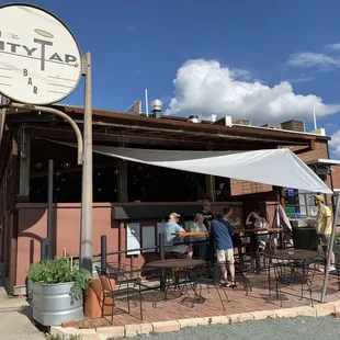 people sitting outside of the restaurant