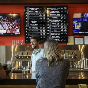 a man and a woman at a bar