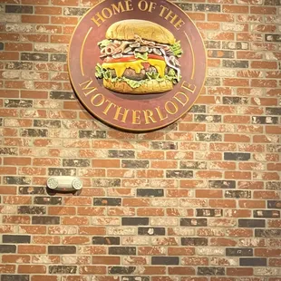 a sign on a brick wall