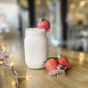 two strawberries in a mason jar