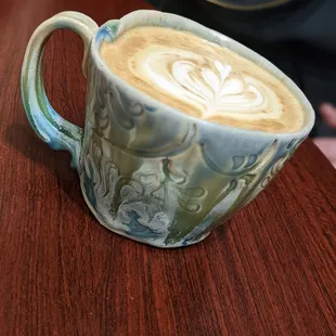 a latte art on a wooden table
