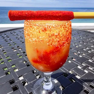 MANGO SUNBURN Frozen mango margarita with chamoy, tajin salted rim and tamarind candied mango straw
