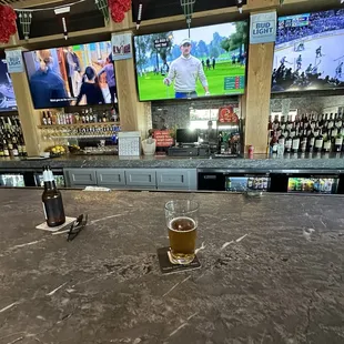 a glass of beer on the bar
