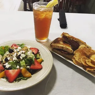 Harvest salad and a Reuben sandwich served with fresh homemade potato chips and an iced tea