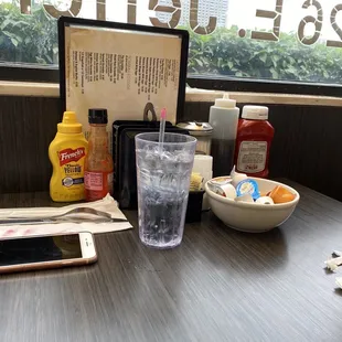 a table with a bowl of food and a drink