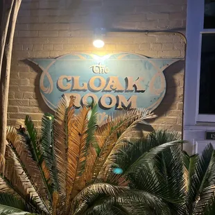 a palm tree in front of the sign