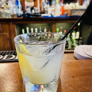 a glass of lemonade on a bar