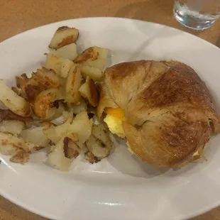 Breakfast croissant with scrambled eggs &amp; cheddar, side of home fries