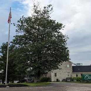 American flag and The Clubhouse at Canewood.