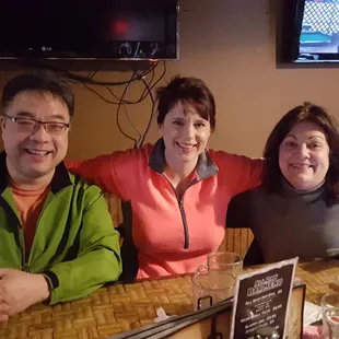 three people sitting at a table