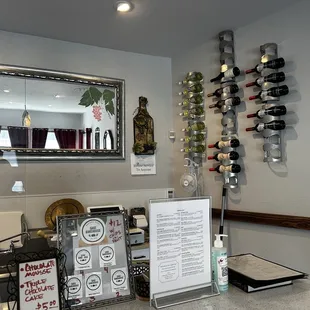 a counter with wine bottles and a menu