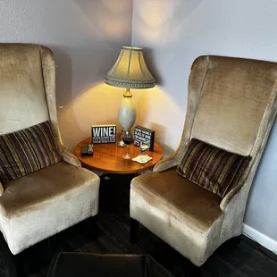 two chairs and a table with a lamp