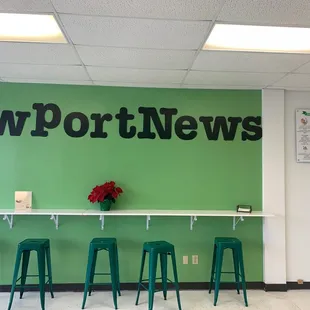 a green wall with a sign that says newport news