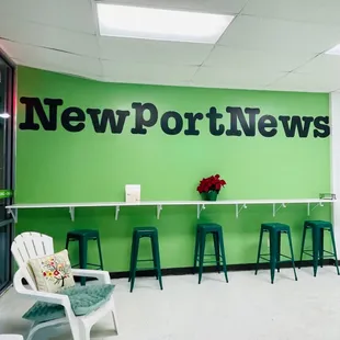a green wall with a news sign