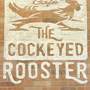 a sign on a brick wall