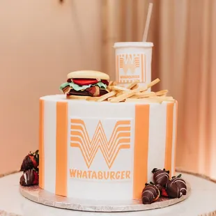 a cake with a burger and strawberries