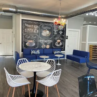 Adorable seating area, rack of flavored coffee syrups in back right corner for sale. Really unique flavors!