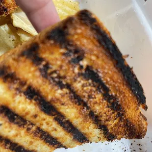 a grilled sandwich and chips