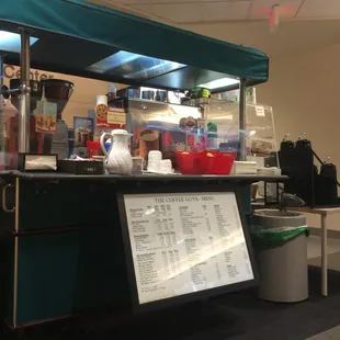 a coffee shop with a menu on the counter