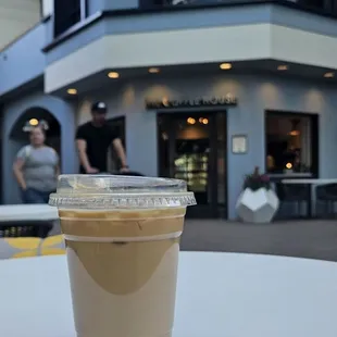 Iced oatmilk latte with a few packets of Sugar in the Raw.