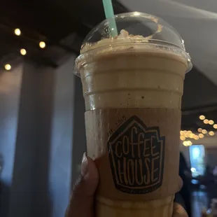 a hand holding a cup of coffee