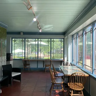 a table and chairs in front of large windows