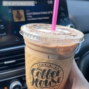 a hand holding a cup of coffee