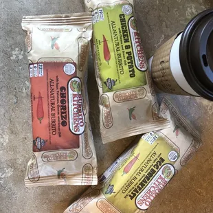 three packets of coffee and a cup of coffee