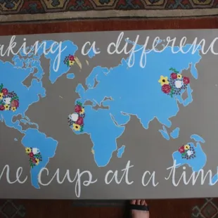 a person holding a sign that says making a difference