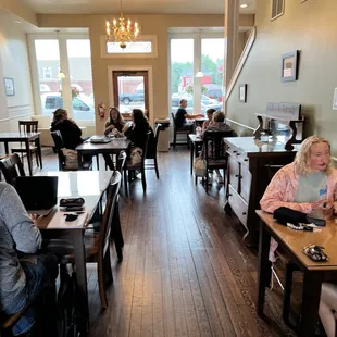 people sitting at tables in a coffee shop
