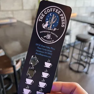 a hand holding a coffee cup