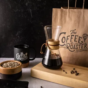 a bag of coffee beans and a coffee grinder