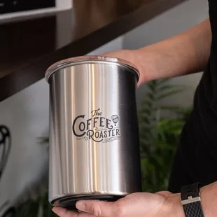 a person holding a coffee pot