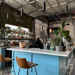  a blue bar with two stools
