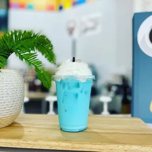 a blue drink and a potted plant