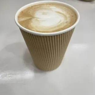 a paper cup of coffee