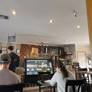 people sitting at tables in a coffee shop