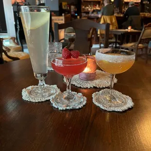 four cocktails on a table