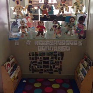 Toddler book area with sign language learning wall.
