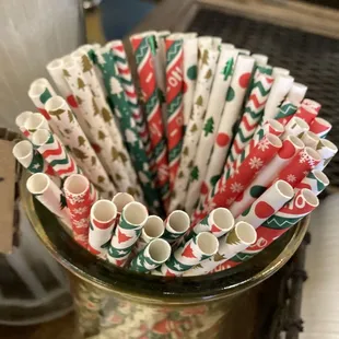 a glass of milk and paper straws