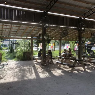 Shaded seating area next to the green with fans and plants