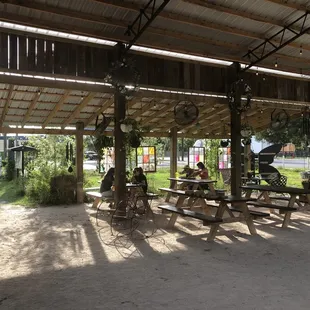 Shaded seating area next to the garden with fans and plants