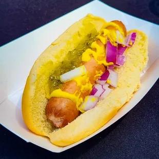 a hot dog with mustard and onions