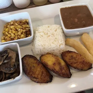 Vegan platter: mushrooms, corn, rice, pintos, yuca fries, plantains. So much goodness happening here.