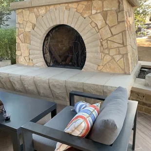 a patio with a fireplace
