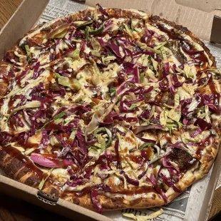 The House Pizza - BBQ base, mozzarella, pulled pork, topped with cilantro coleslaw &amp; sriracha ranch.