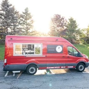 a red van parked in a parking lot